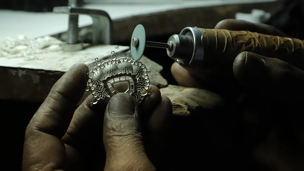 Jewelry artisan shaping gold at Strong Gold